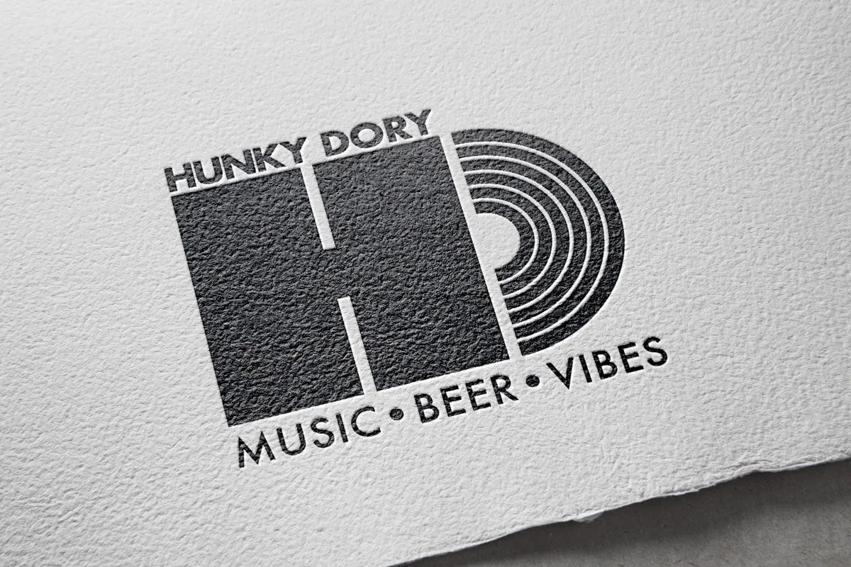 The Hunky Dory HD logo, letterpressed on textured paper, with the line Music · Beer · Vibes