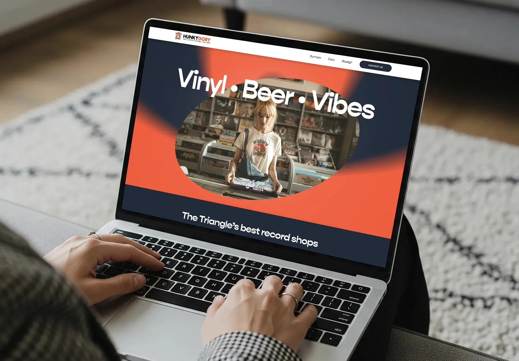 The Hunky Dory website on a laptop: Vinyl · Beer · Vibes over a photo of the store