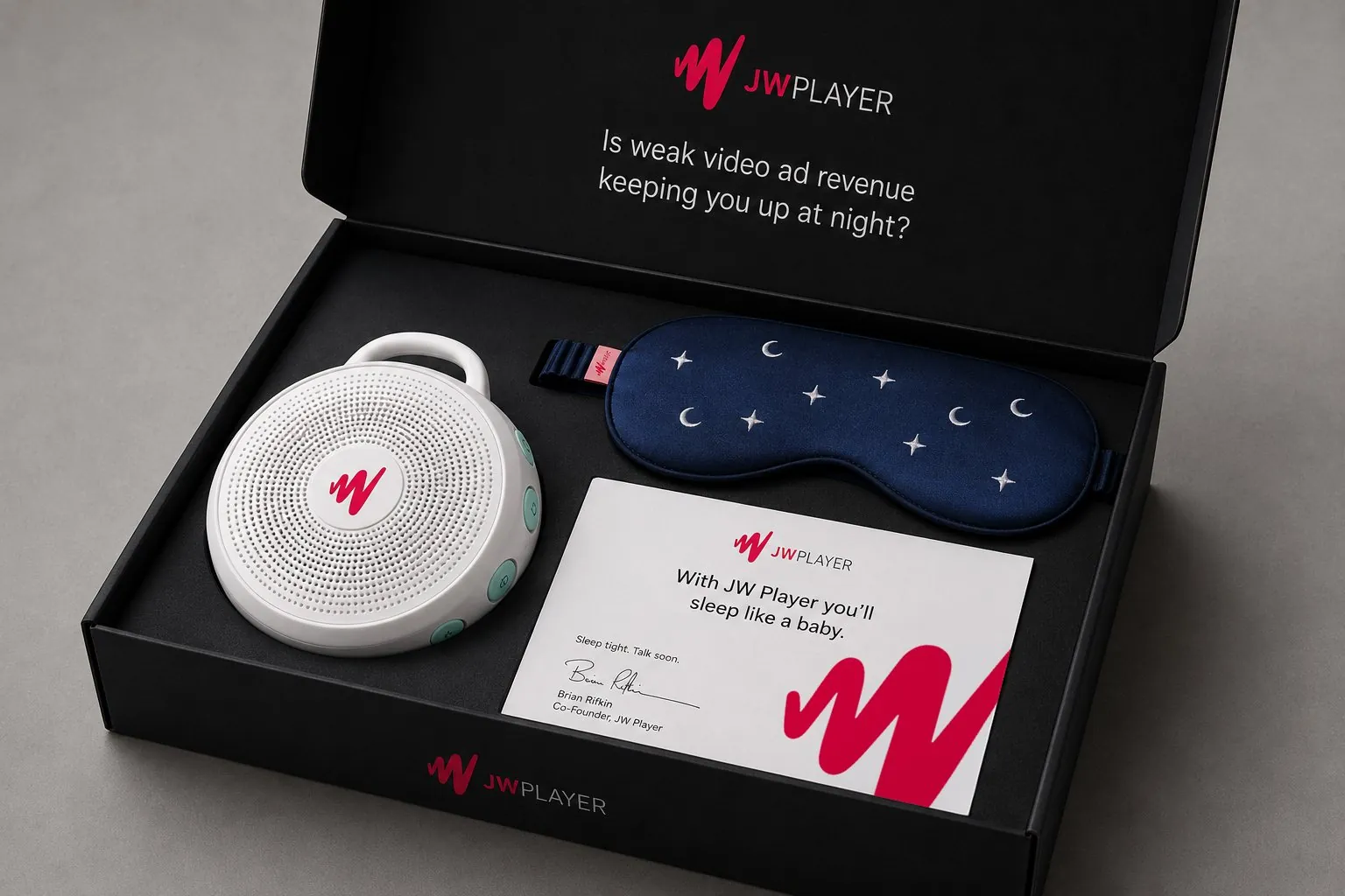 The sleep kit in its black box: a JW Player white-noise machine, a starry sleep mask and a card reading With JW Player you’ll sleep like a baby