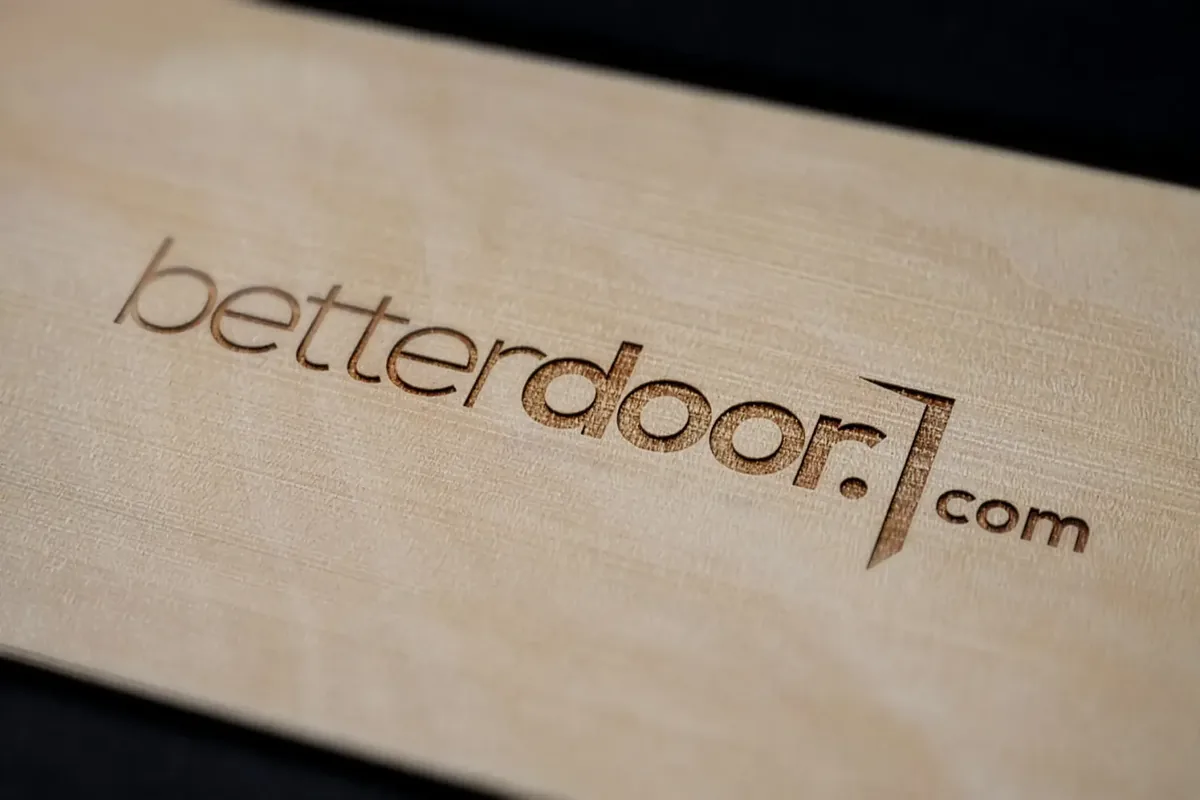 betterdoor.com logo laser-engraved into a birch wood panel