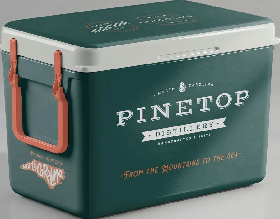 A deep green Pinetop cooler with coral handles, the Pinetop lockup and From the Mountains to the Sea on the front