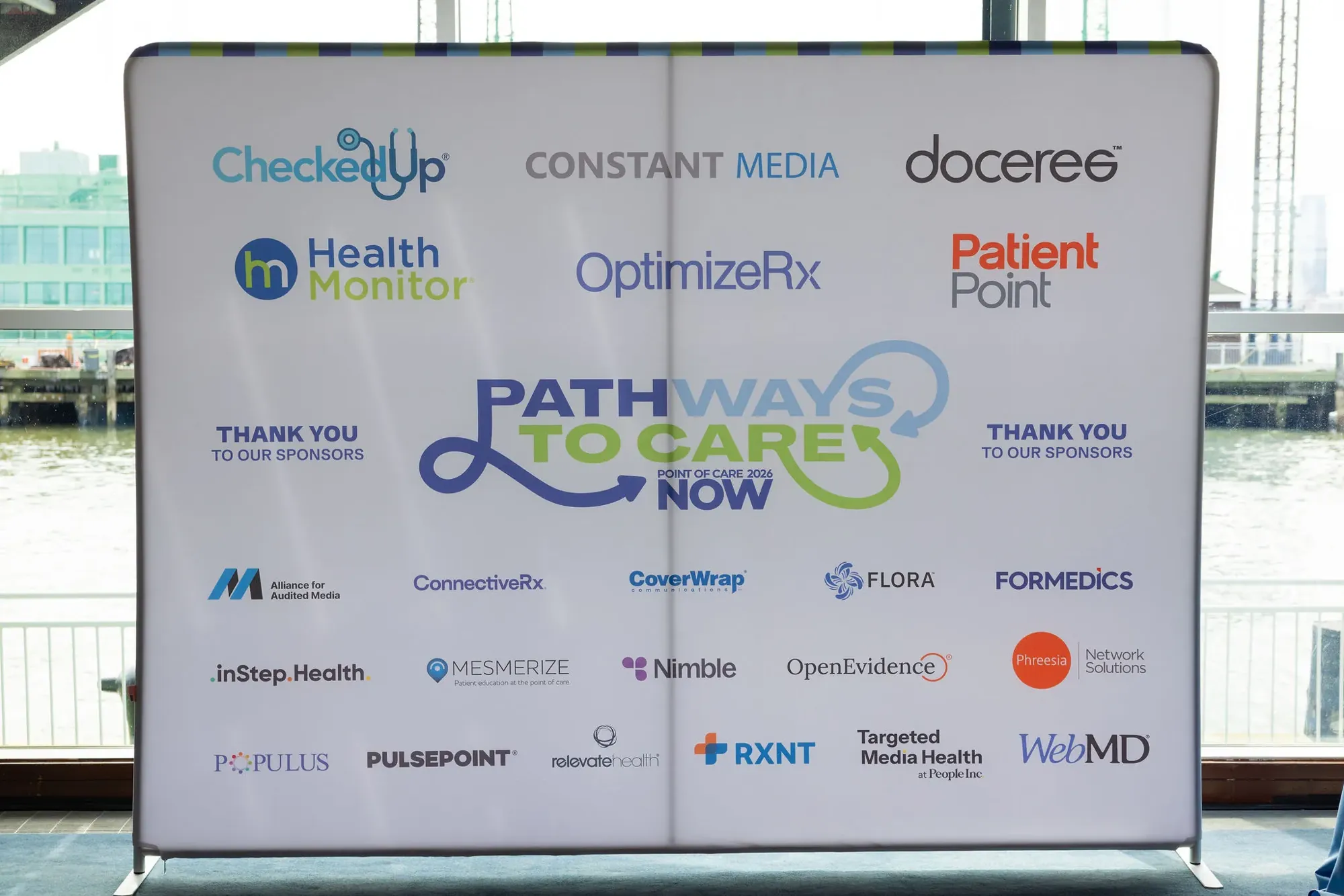 The sponsor wall: 22 sponsor logos around the Pathways to Care logo, with Thank you to our sponsors on each side and a striped top edge