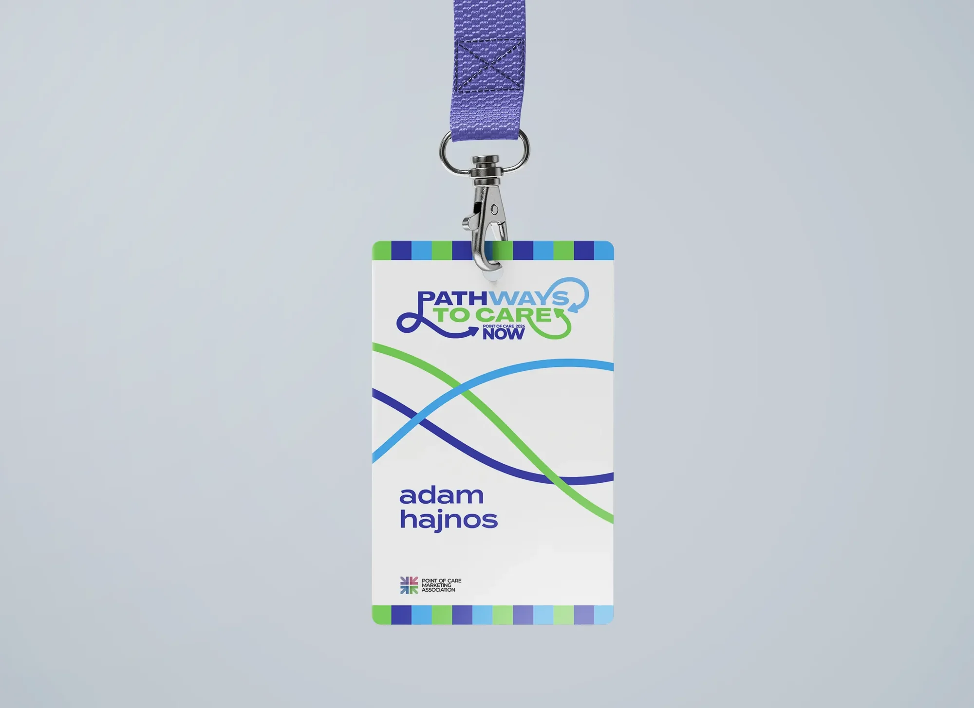 A Pathways to Care attendee badge on a purple lanyard: the logo, three crossing lines in blue, green and navy, the attendee name, the POCMA mark and striped edges